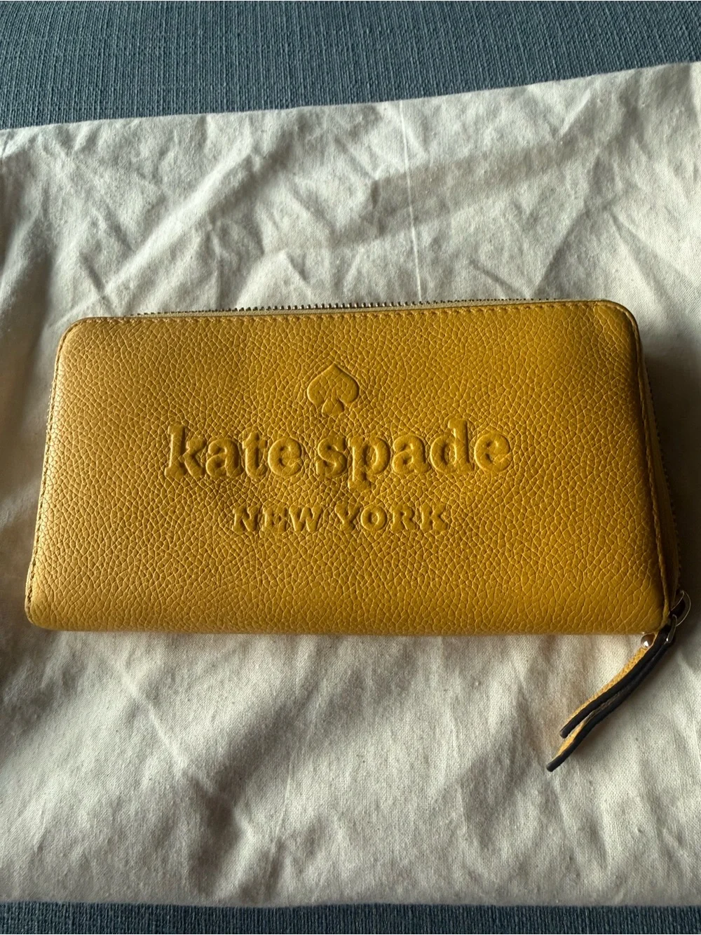 kate spade New York yellow zip-around pebbled leather wallet